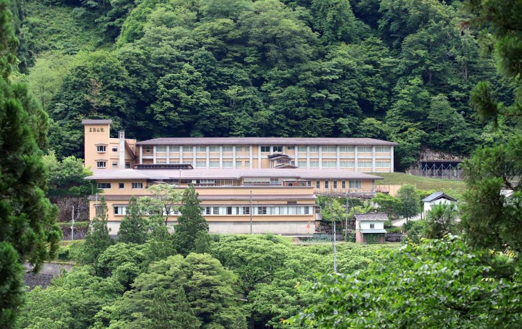 a large building in the middle of a mountain at Gokasanso in Nanto