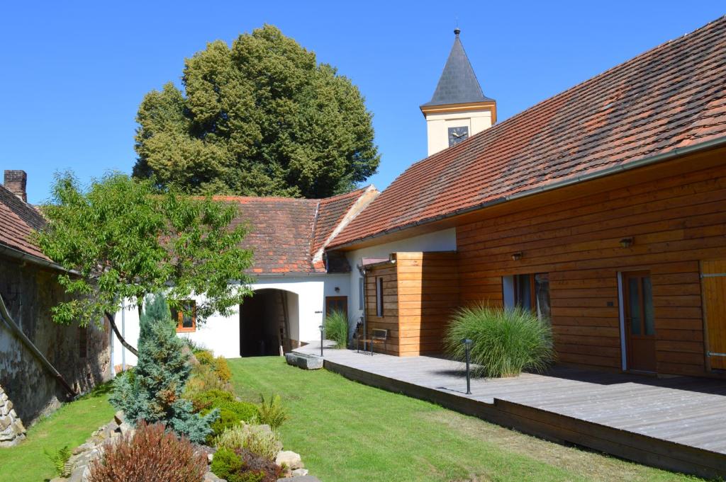 a house with a wooden building and a tower at Vincentův dvůr in Paračov