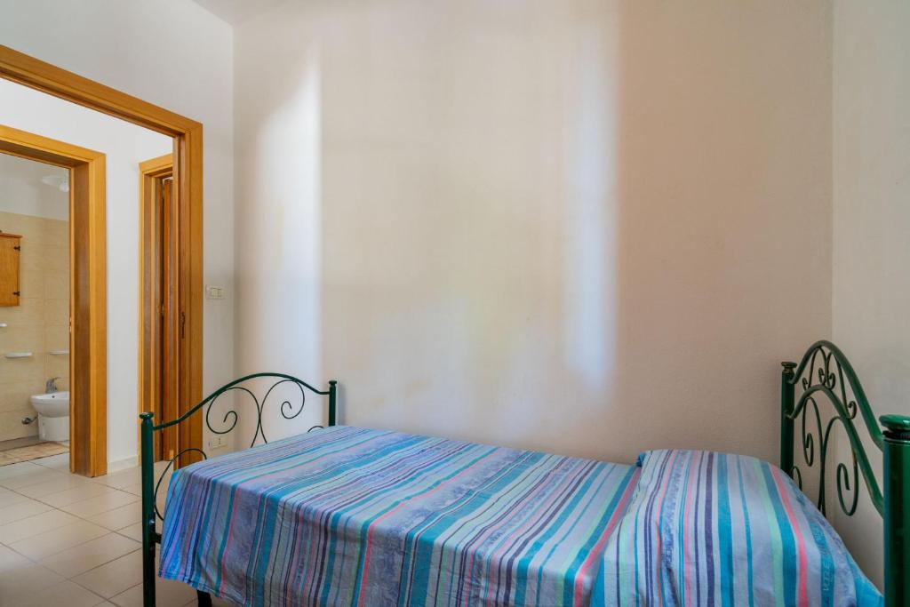 Łóżko lub łóżka w pokoju w obiekcie Tenuta La Saracina - Villino 1