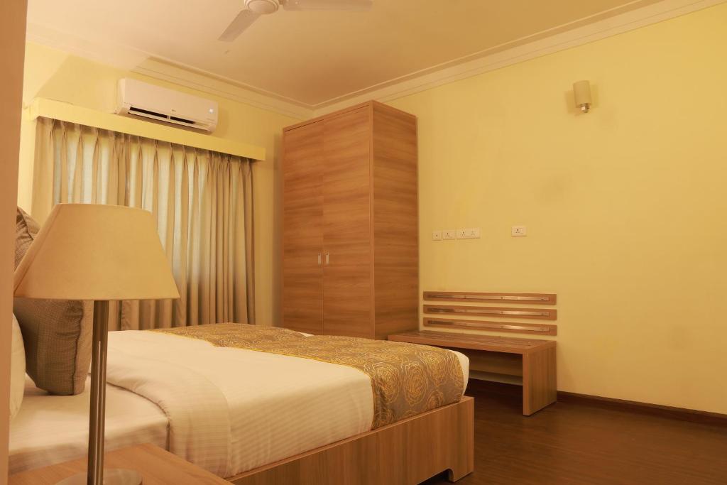 Postel nebo postele na pokoji v ubytování Starlit Suites Tirupati