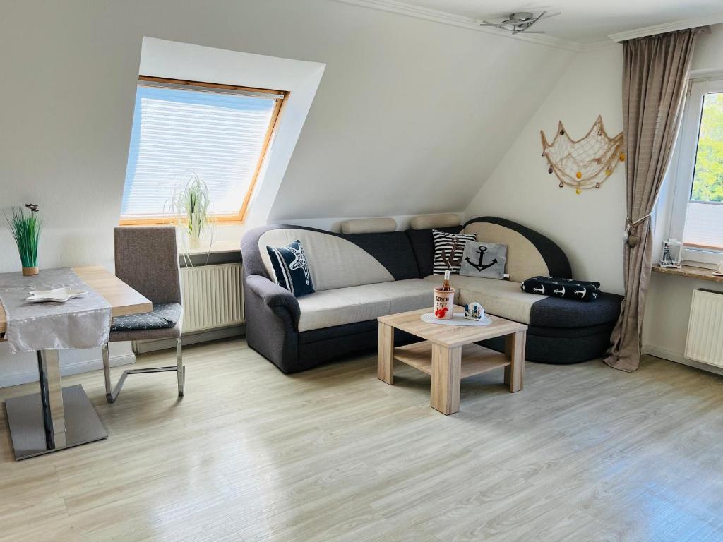 a living room with a couch and a table at Haus Larum App. 5 in Scharbeutz