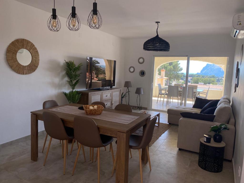 ein Esszimmer und ein Wohnzimmer mit einem Tisch und Stühlen in der Unterkunft Stark - AzulenaCalpe in Calpe