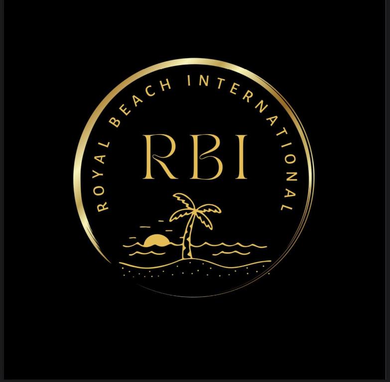 a gold coin with a palm tree and the words rbi at Royal Beach International in Puri