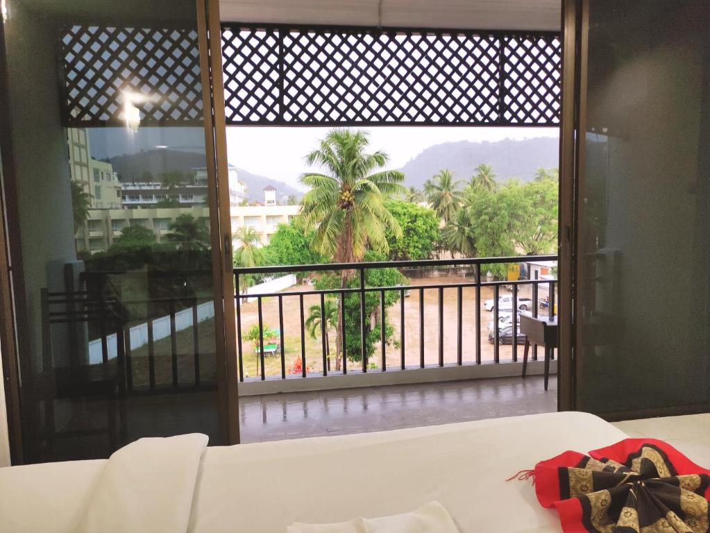 a bedroom with a view of a balcony at Sea Beach Paradise in Patong Beach