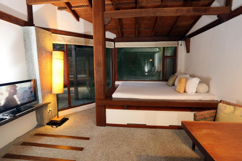a bedroom with a bed and a tv in a room at Mudanwan Villa in Mudan
