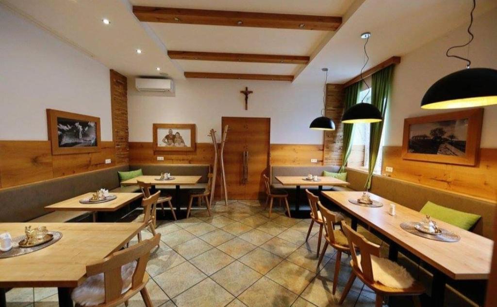 a dining room with wooden tables and chairs at Gasthof Prinz 