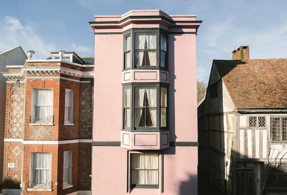 a pink building with windows on the side of it at Roselina in Hastings