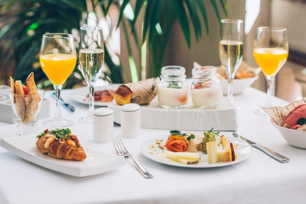 a table with plates of food and glasses of wine at Iberostar Heritage Grand Mencey in Santa Cruz de Tenerife