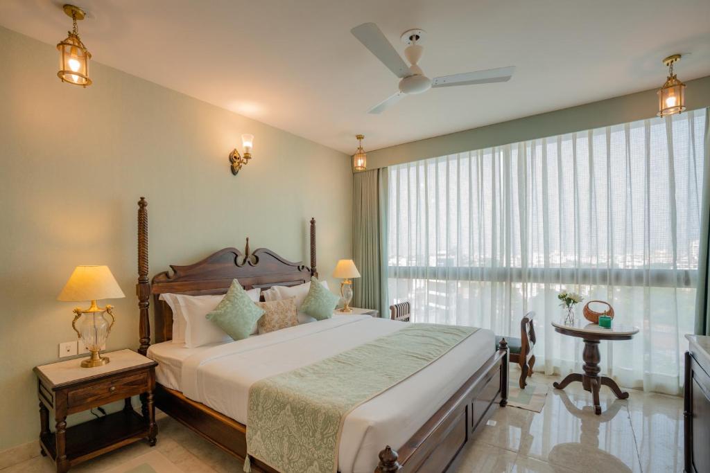a bedroom with a large bed and a large window at 35 Sahakar Suites-A Luxury Aparthotel in Jaipur in Jaipur