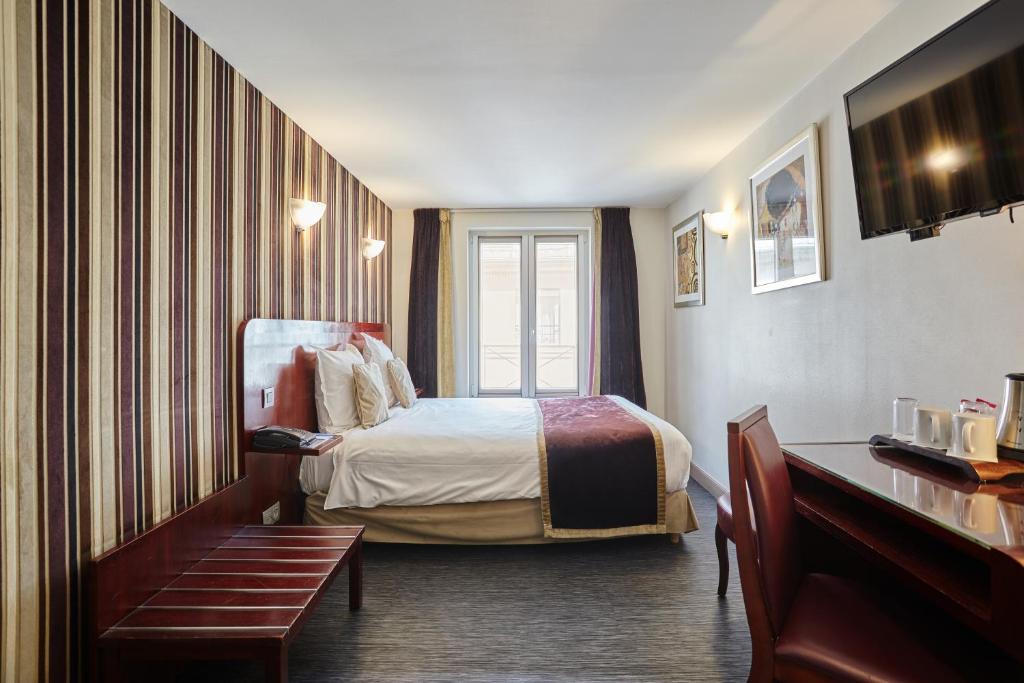a hotel room with a bed and a window at Hotel Opéra d'Antin in Paris
