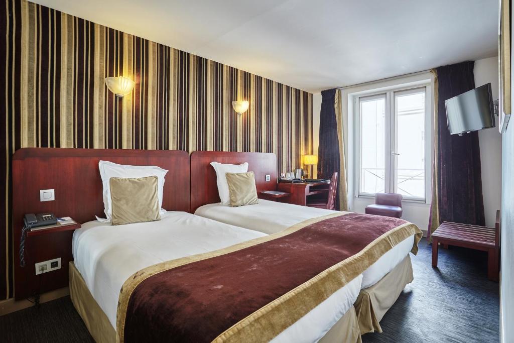 Postel nebo postele na pokoji v ubytování Hotel Opéra d'Antin