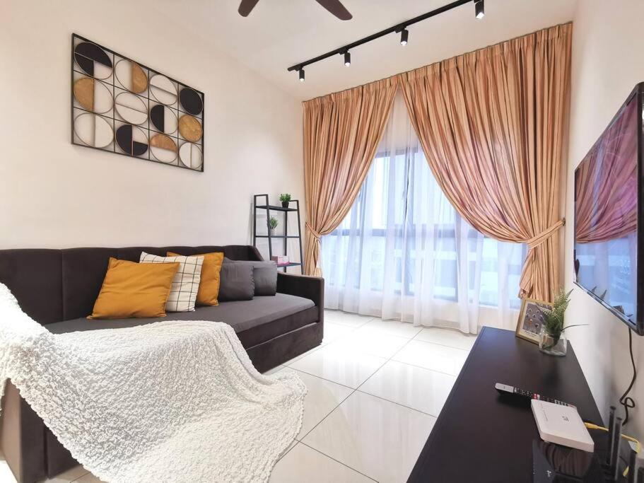 a living room with a couch and a large window at 4 Traders Garden 1 Bedroom Pool View Netflix WiFi in Cheras