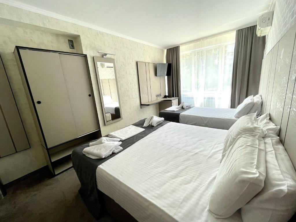 Postel nebo postele na pokoji v ubytování Hotel Cosmos