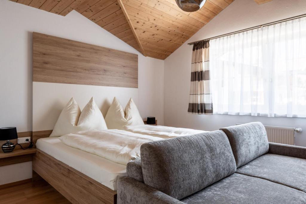 sypialnia z dużym łóżkiem i kanapą w obiekcie Gschwendtners Apartment w mieście Werfenweng