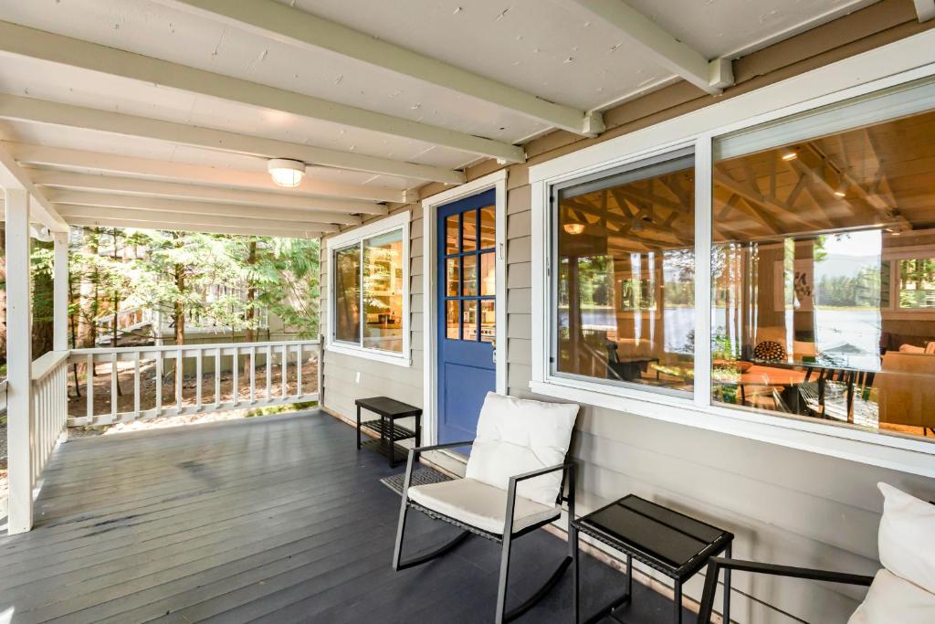 a screened porch with a white chair and windows at Sunset Chalet at Lake Alice in Fall City