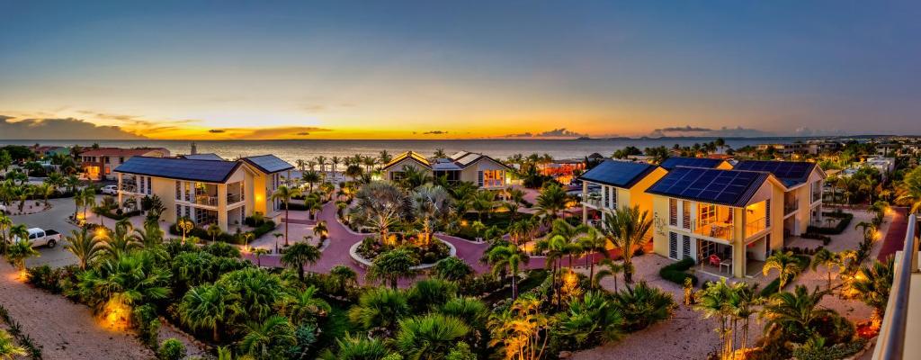 an aerial view of a resort at sunset at Delfins Beach Resort in Kralendijk