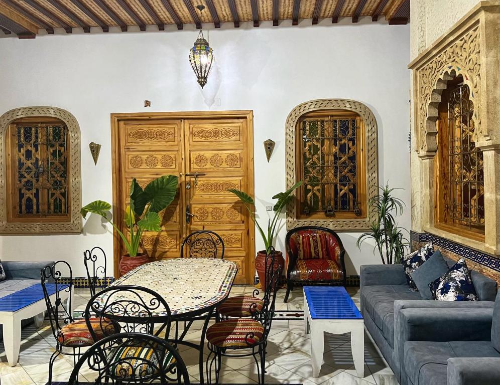 a living room with a table and a couch at Dar Rehab in Rabat