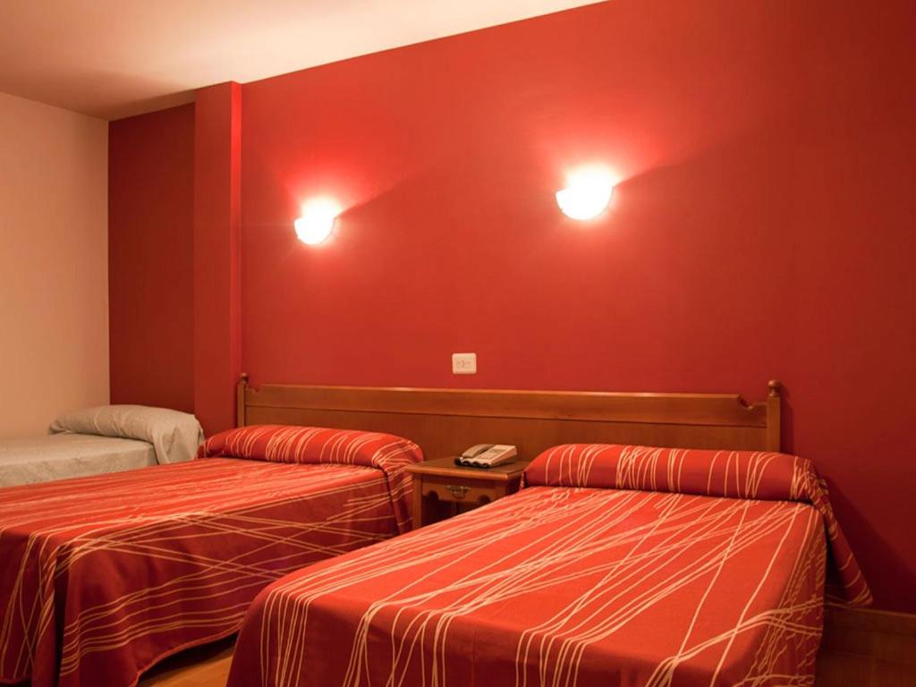 Łóżko lub łóżka w pokoju w obiekcie Hostal Las Vegas