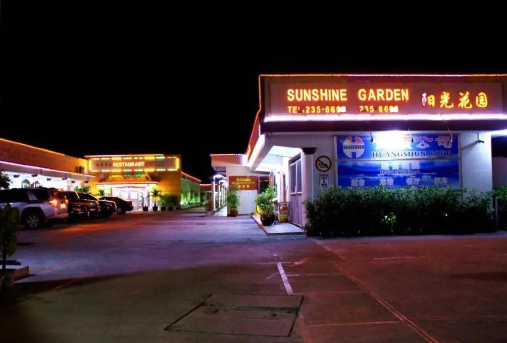 a building with a sign that reads sunshine garden the brightest shop at Sunshine Garden in Susupe