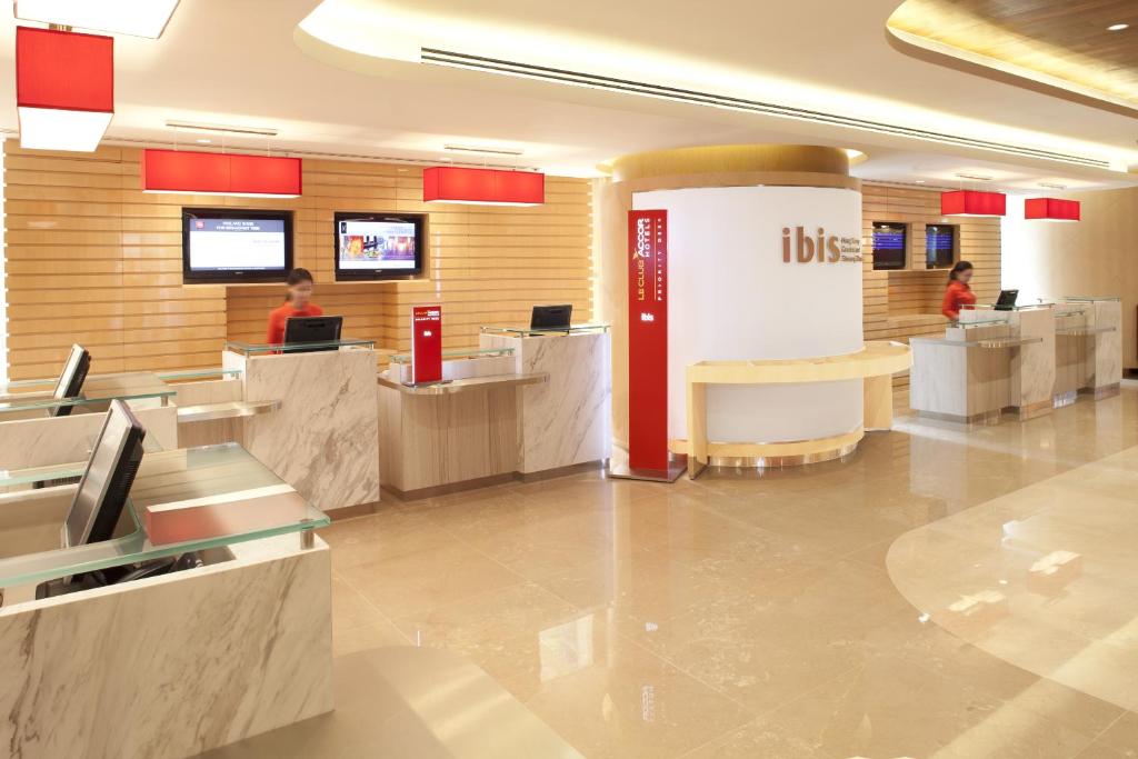 a lobby of a hotel with people sitting at computers at Ibis Hong Kong Central & Sheung Wan in Hong Kong