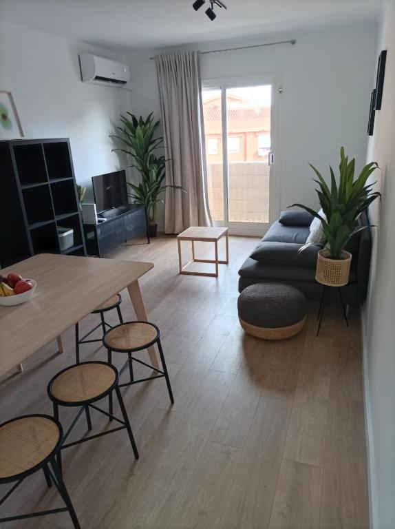 a living room with a table and a couch at COOL! 5' to metro. 15' to Center/beach by metro. in Santa Coloma de Gramanet