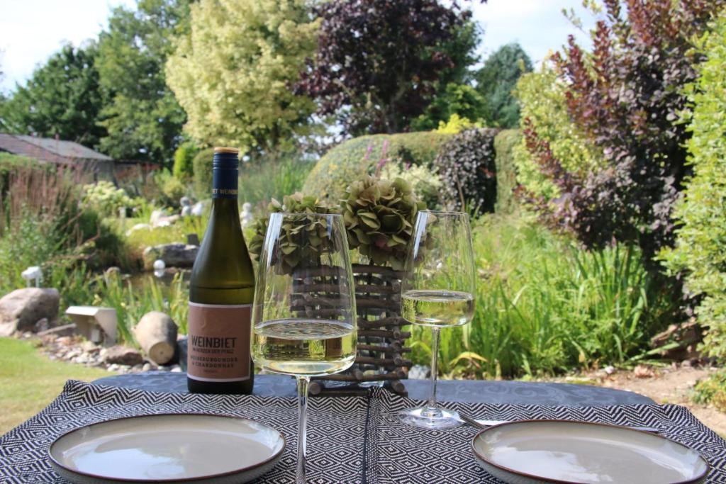 a bottle of wine and two glasses on a table at Haus Am Damm in Kleve