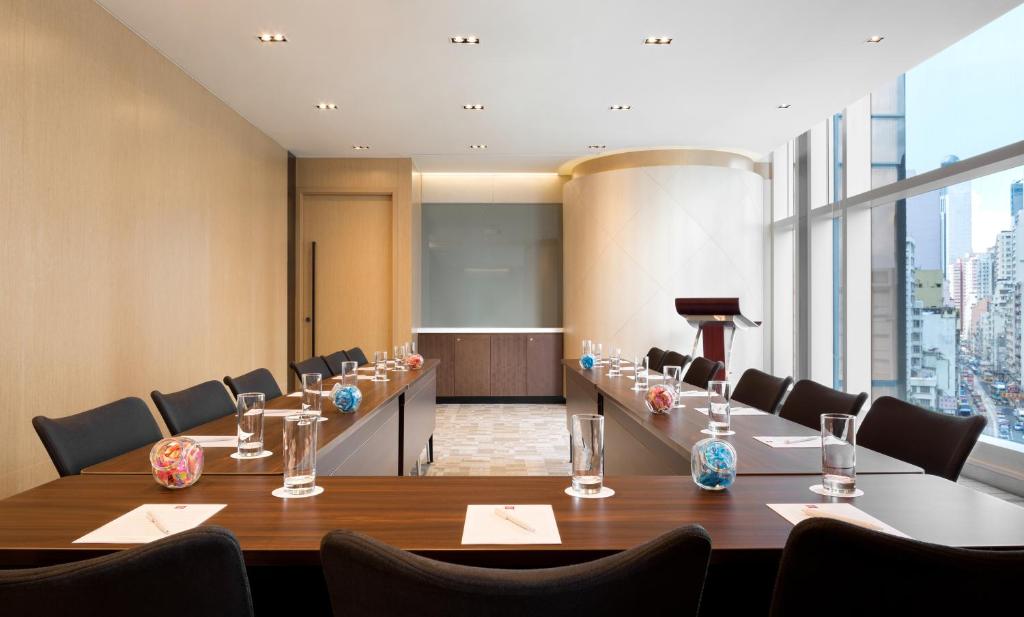 a conference room with a long table and chairs at Ibis Hong Kong Central & Sheung Wan in Hong Kong