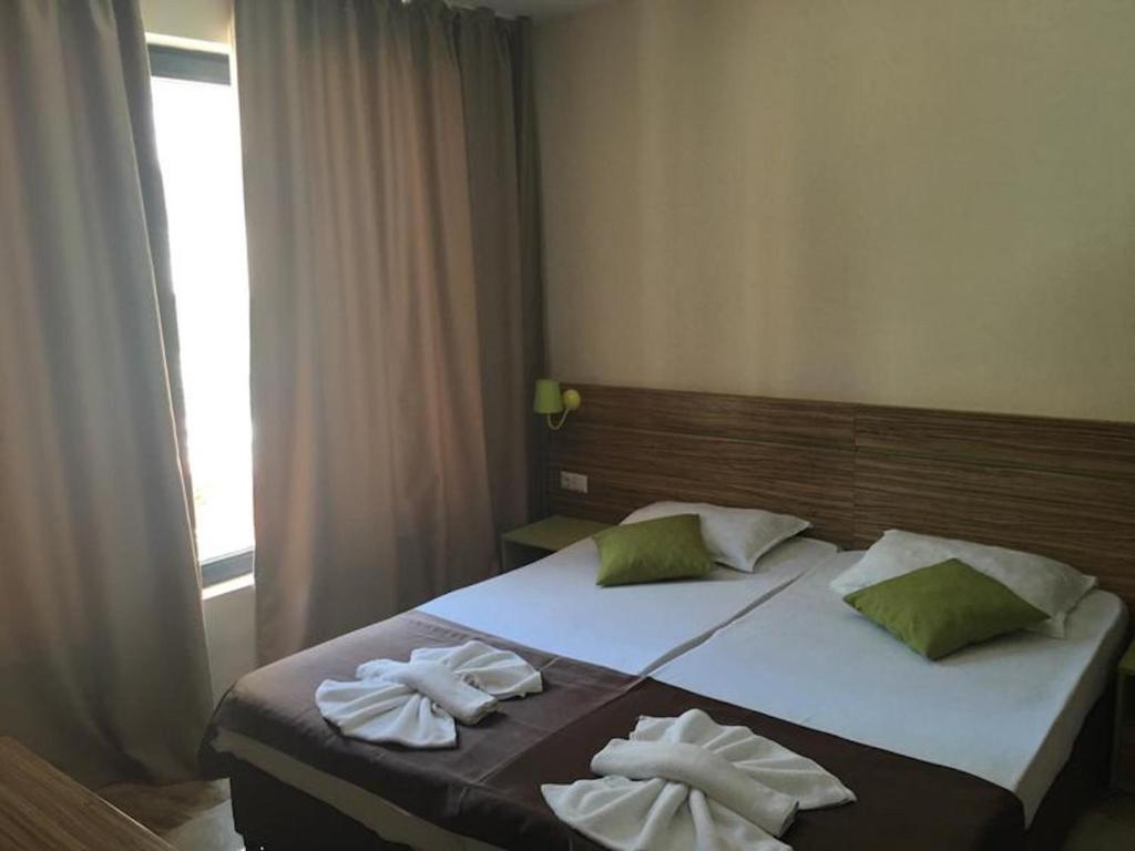 a bedroom with a bed with two towels on it at Hotel Tm Deluxe located in Sunny Beach in Sunny Beach