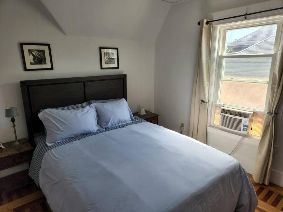 a bedroom with a large bed and a window at Lovely two bedroom apartment with free parking in Manchester