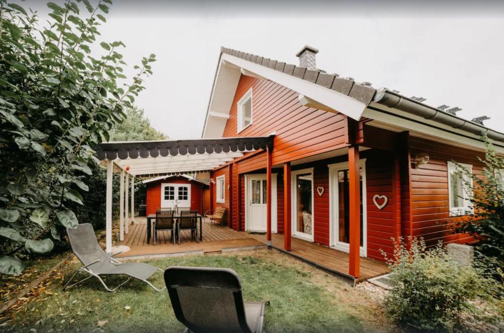 a house with a deck with a table and chairs at Haus Hanni Zarrentin am Schaalsee in Zarrentin