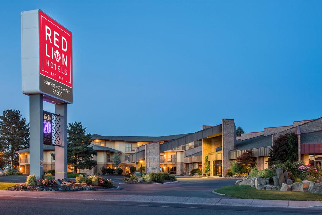 a red hotel sign in front of a building at Red Lion Hotel Pasco Airport & Conference Center in Pasco