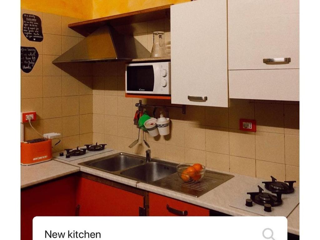 Una cocina o kitchenette en "Private Room" stanza privata with private bathroom - shared kitchen and beautiful terrace on Taormina Center Hostel Taormina