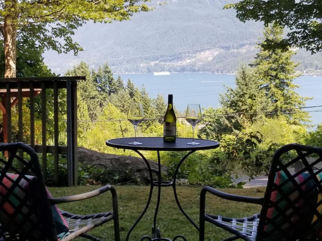 a bottle of wine sitting on a table on a patio at Hummingbird Hut in Bowen Island