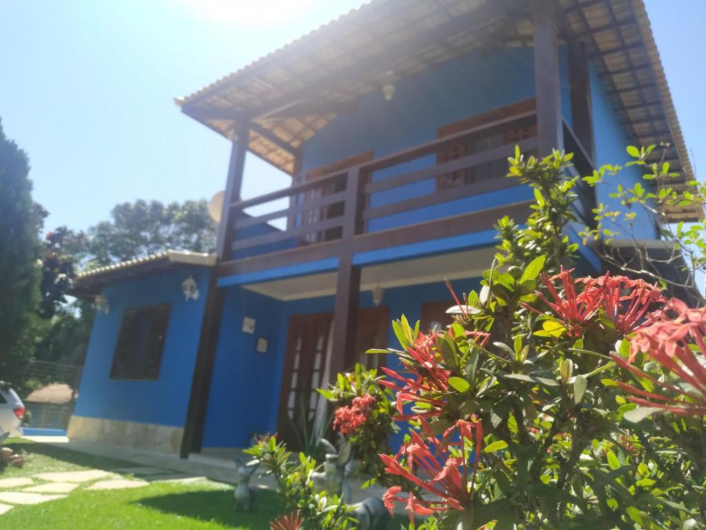 a house with a blue facade and some flowers at Casa Azul em Búzios in Búzios