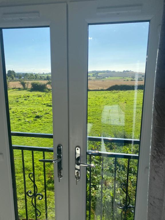 an open door with a view of a field at Wilkinson farm in Blackrod