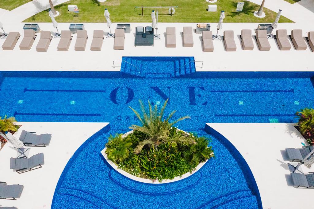 an overhead view of a swimming pool with a blue water at ONE Canal Point in Upper Land