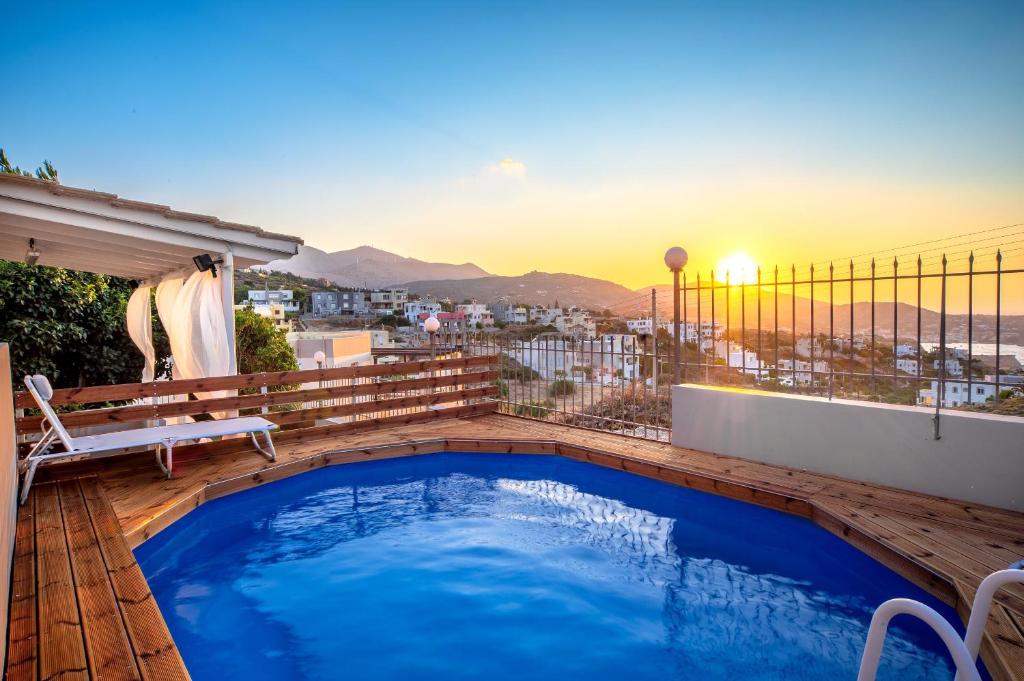 a swimming pool on a balcony with a view of the city at ARISMARI Garden Apartment in Lygaria