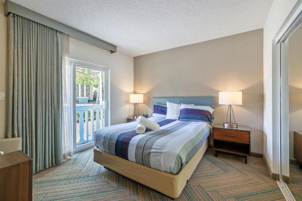 a bedroom with a bed and a large window at The Malone in Miami