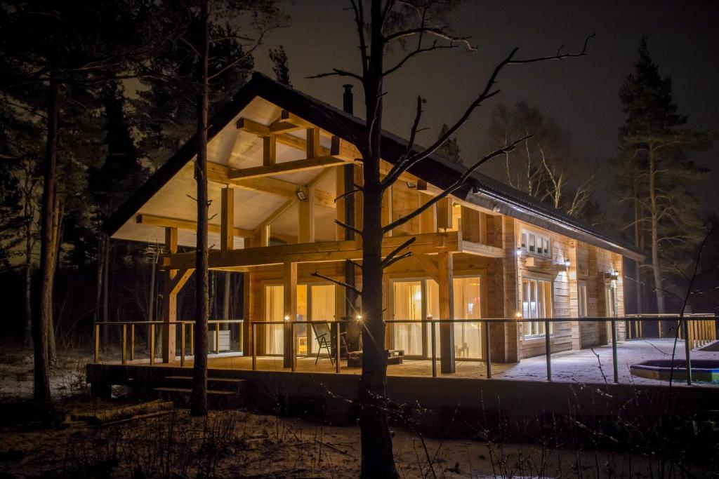 a house in the woods at night at Hapsal Holiday Homes in Haapsalu