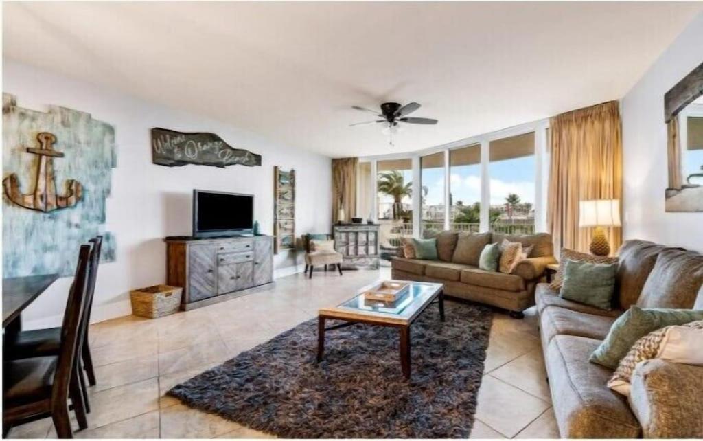 a living room with a couch and a table at Caribe Resort Unit C211 in Orange Beach