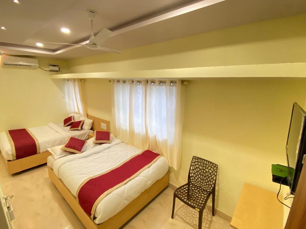 Postel nebo postele na pokoji v ubytování Prabhuvihar Residency
