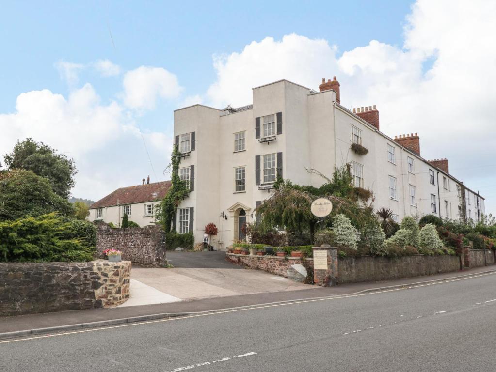 a large white building on the side of a street at Alcombe House in Minehead