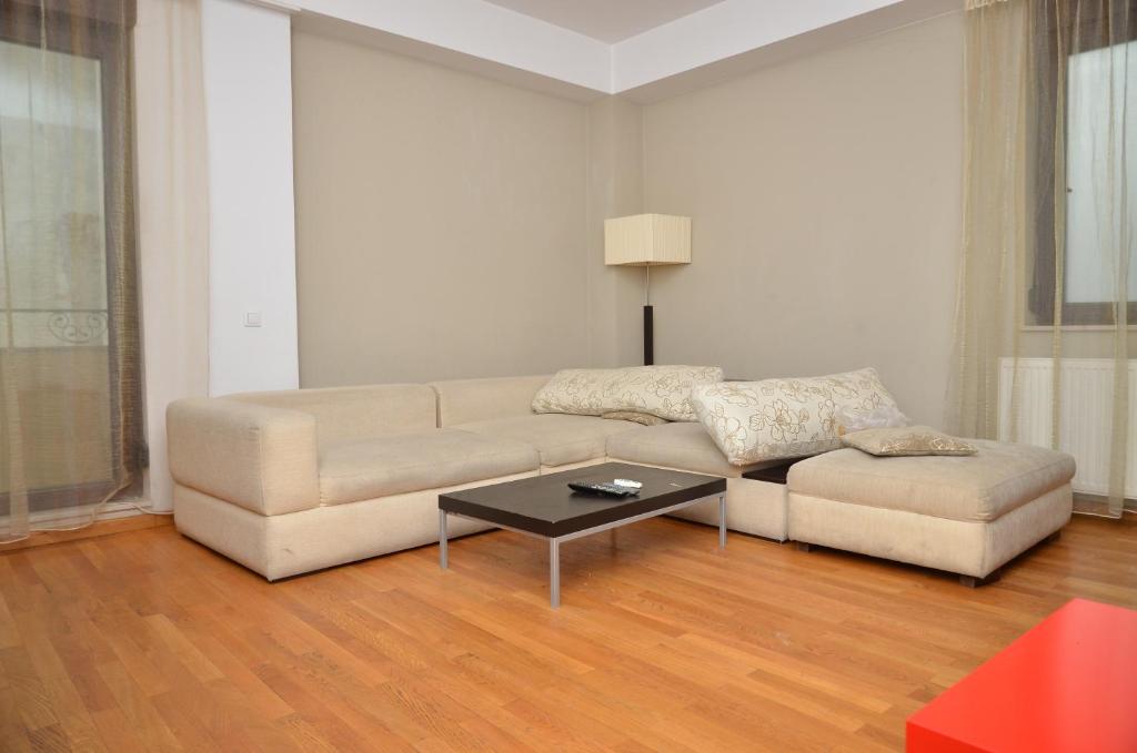 a living room with a couch and a coffee table at Downtown Accommodation in Bucharest
