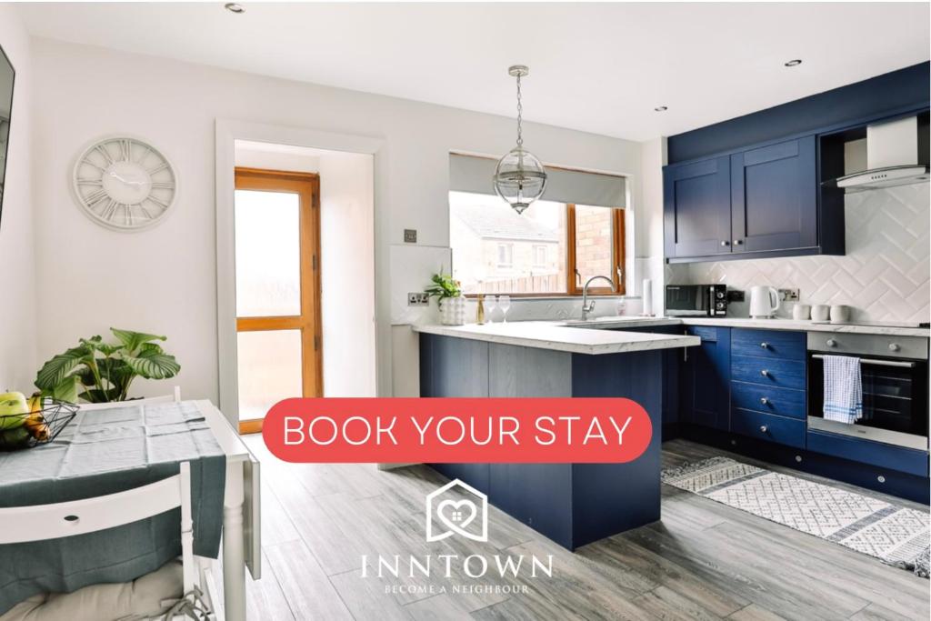a kitchen with blue cabinets with the words book your stay at FAMILY TOWN HOUSE (with garden & private parking) in Belfast