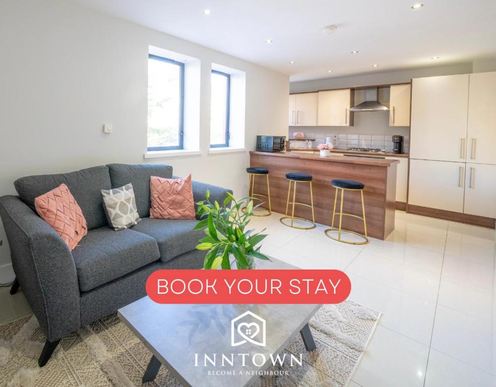 a living room with a couch and a kitchen at BOTANIC APARTMENT SLEEPS 6 in Belfast