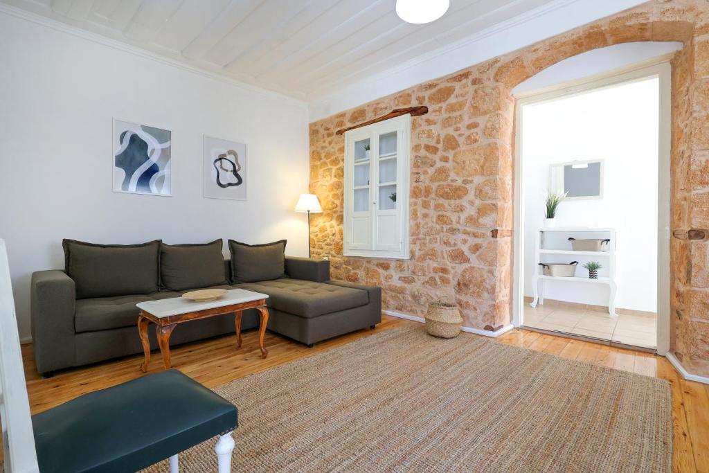 a living room with a couch and a table at Feidiou 1 in Egina