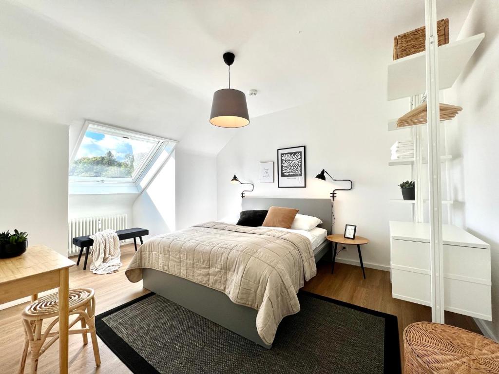 a white bedroom with a bed and a table and chairs at Wohntraeumerei Bergblick- Ihr privates Hideaway in Bad Berleburg, einem Wanderparadies in Bad Berleburg