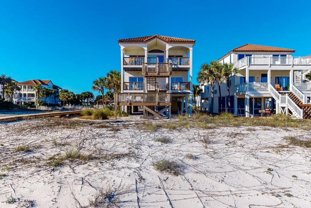 a building on the beach next to the sand at Beach Boy in St. George Island