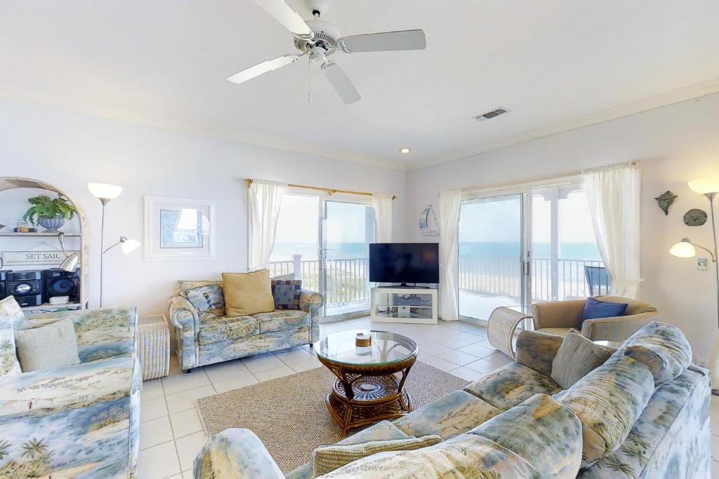 a living room with a couch and chairs and a television at King's Crown in St. George Island