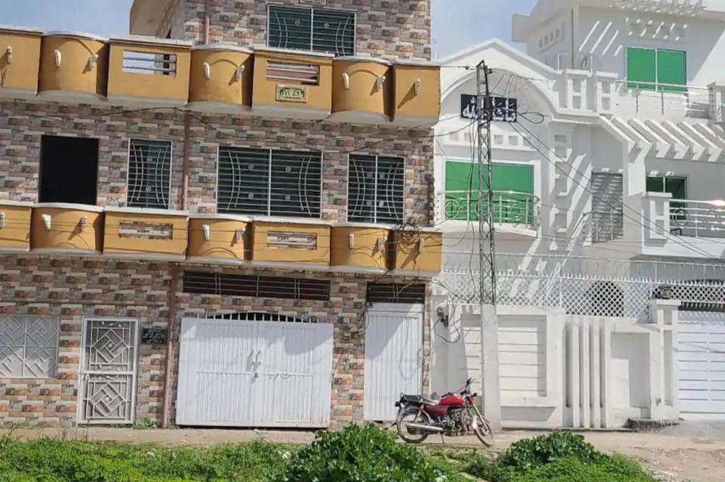 a motorcycle parked in front of a brick building at Remarkable 3-Bedroom 